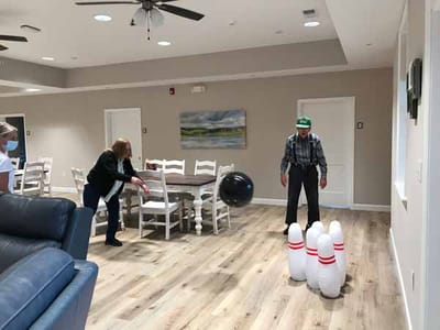 Residents enjoying bowling activity in a common area