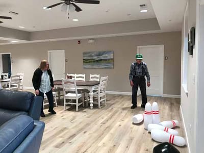 Residents participating in a bowling activity indoors