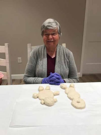 A resident engaged in an activity with dough figures