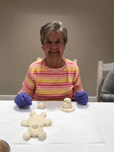 Resident enjoying a baking activity with dough figures