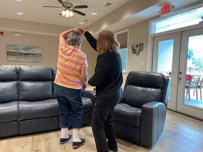 Staff assisting a resident in a common area