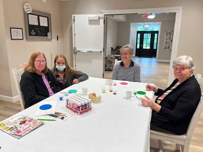 Residents engaged in a crafting activity at a table
