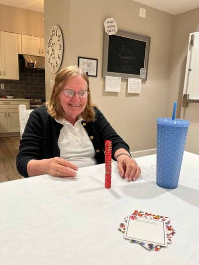 Resident participating in an activity at a table