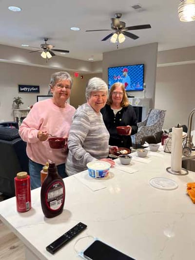 Residents enjoying an activity in a common area kitchen