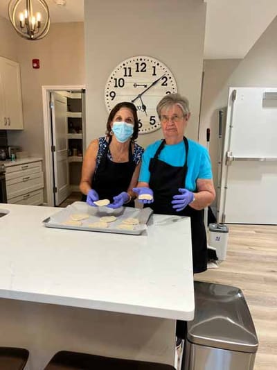 Residents baking cookies in a kitchen