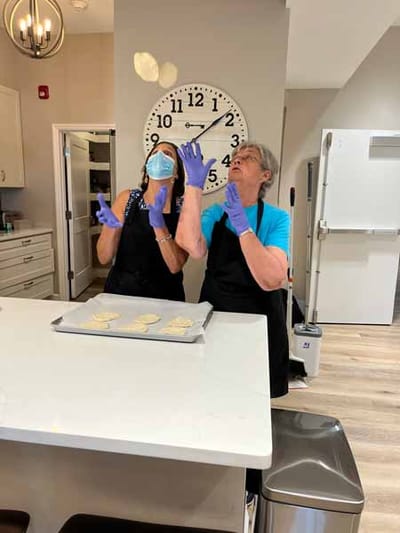 Staff and a resident baking in the kitchen