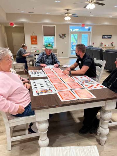 Residents engaging in a card game in a common area