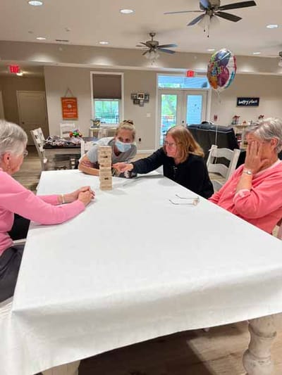 Residents engaged in a game activity in a communal space