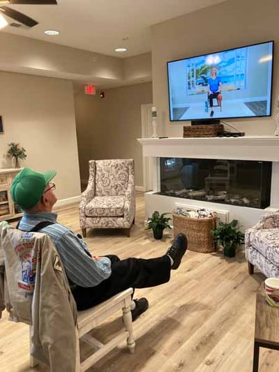 Resident watching a show in a cozy common area