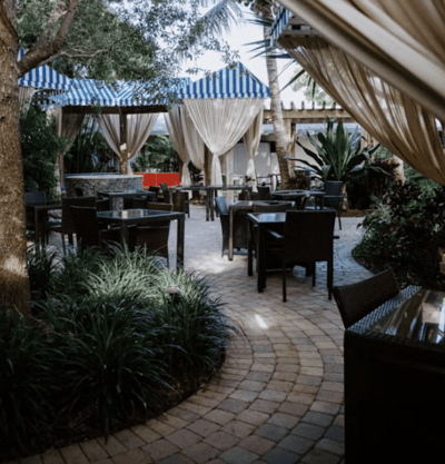 Outdoor patio area with seating and greenery