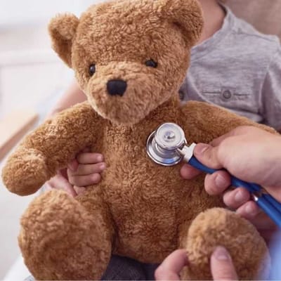 Child with a teddy bear and stethoscope