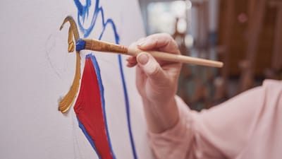 Close-up of a hand painting on a canvas