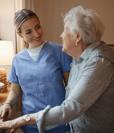 Staff member smiling with a resident.