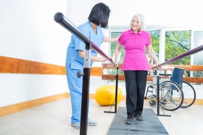 Physical therapy session with resident and staff member.