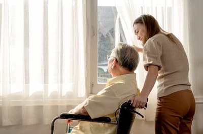 Caregiver interacting with a resident by the window