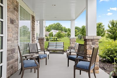 Outdoor seating area with chairs and greenery