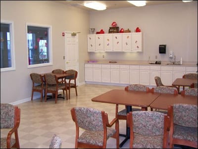 Common area with tables and chairs in facility