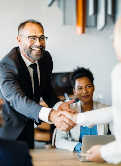 Business colleagues shaking hands in a meeting