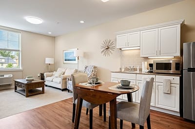Bright interior of a resident's living space with kitchen and dining area
