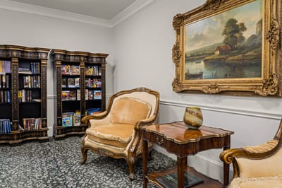 Cozy sitting area with bookshelves and artwork