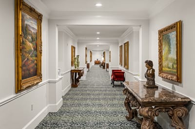 Well-decorated hallway with art in a senior living facility
