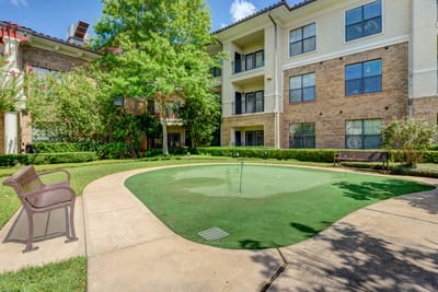 Outdoor courtyard with greenery and seating area