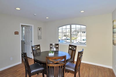 Bright common area with a dining table and chairs