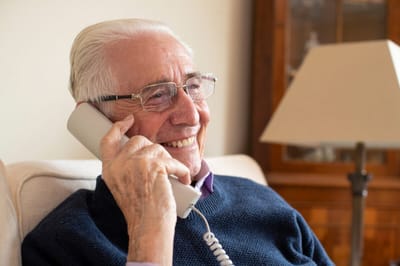 Smiling elderly man talking on the phone
