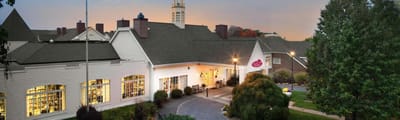 Exterior view of an assisted living facility with landscaped gardens