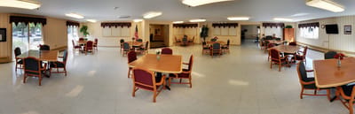 Panoramic view of a common area with tables and chairs