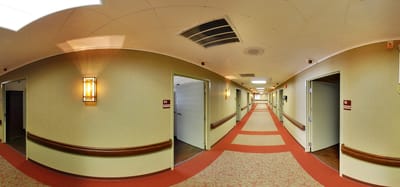 Interior corridor with resident rooms and lighting