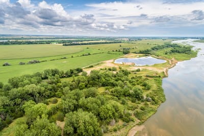 Aerial view of a serene landscape with water and greenery