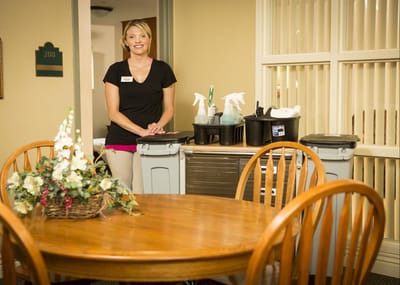 Staff member standing in a facility dining area