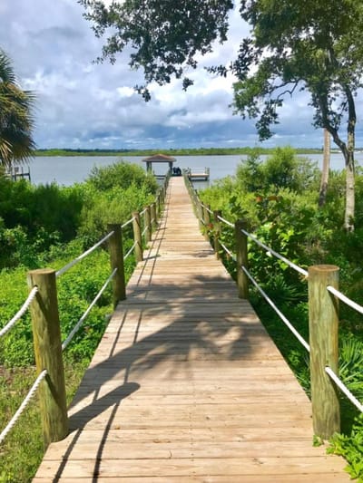 Wooden walkway leading to a serene waterfront