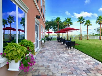 Outdoor patio area with tables, chairs, and umbrellas