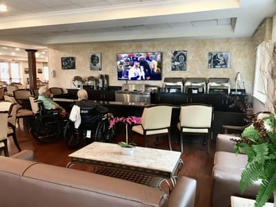 Residents enjoying a common area watching TV