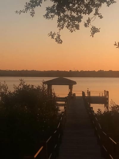 Dock by the water during sunset