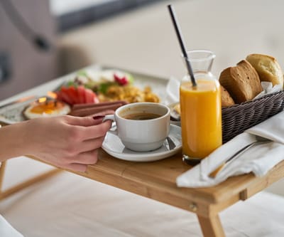 Breakfast tray with coffee, juice, and bread