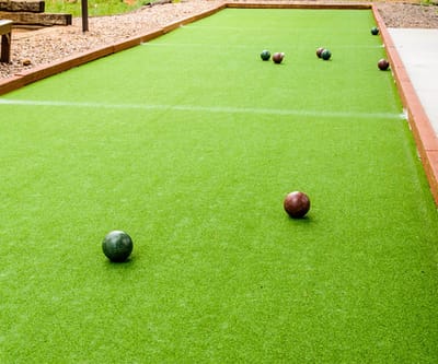 Outdoor bowling green with colored balls on turf