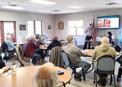 Residents attending an informative presentation in a common area