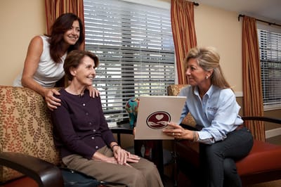 Staff member engaging with residents in a communal area