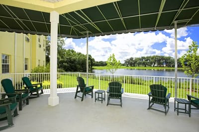 Deck chairs overlooking a serene pond and garden area