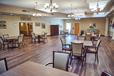 Bright and spacious common area with dining tables