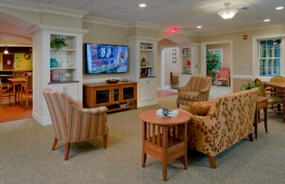 Bright common area with seating and a TV