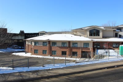 Exterior view of Assisi Village building in winter