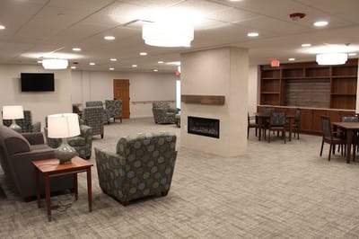 Bright, inviting common area with seating and fireplace