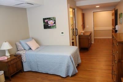 Cozy resident room with a bed and wooden furniture