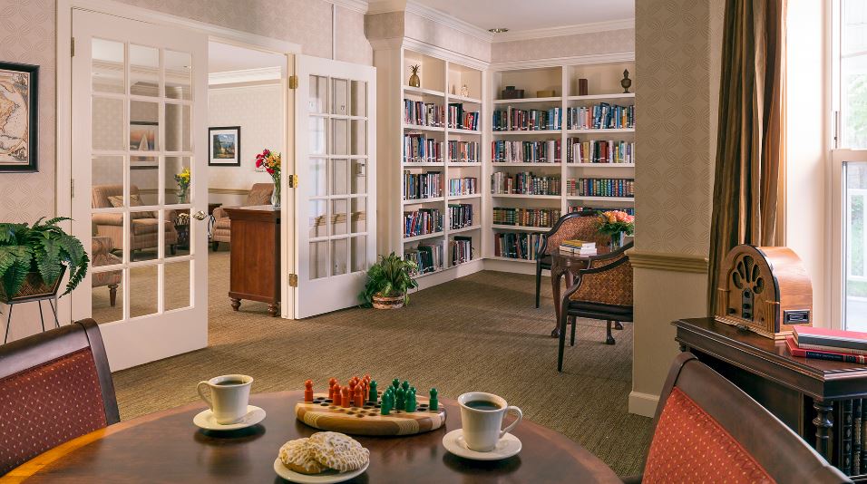 Cozy common area with bookshelves and coffee setup
