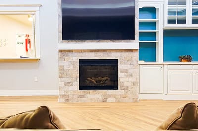 Cozy common area with a fireplace and TV