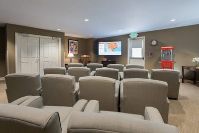 Activity room set up with chairs and a TV